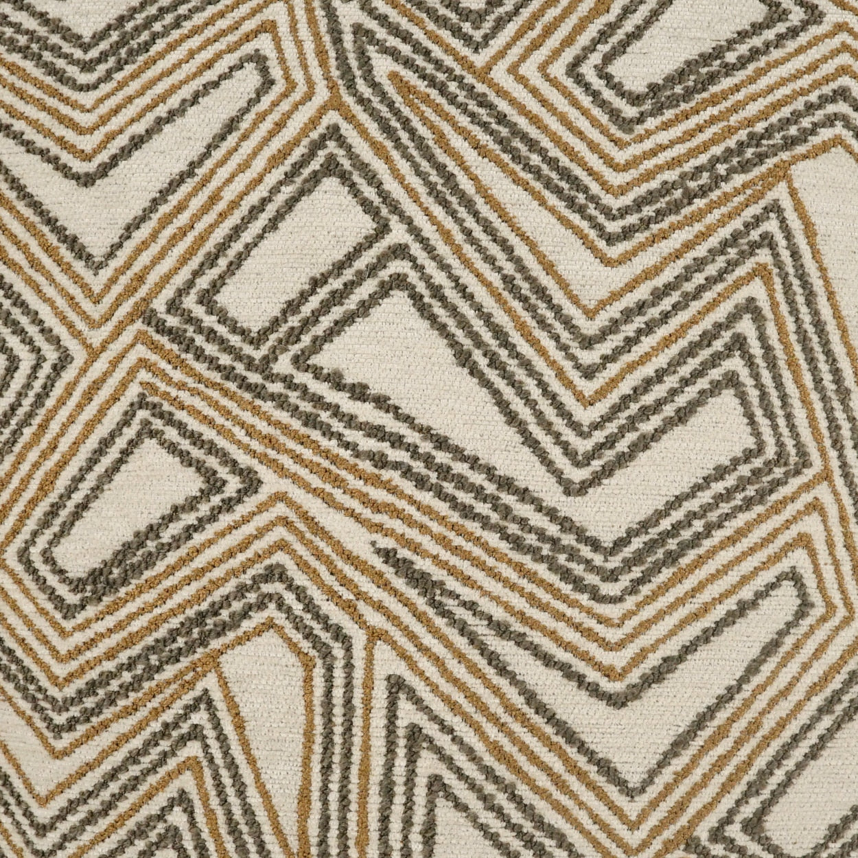 Geometric chevron rug in beige, tan and gray; woven textile with bold zigzag pattern.
