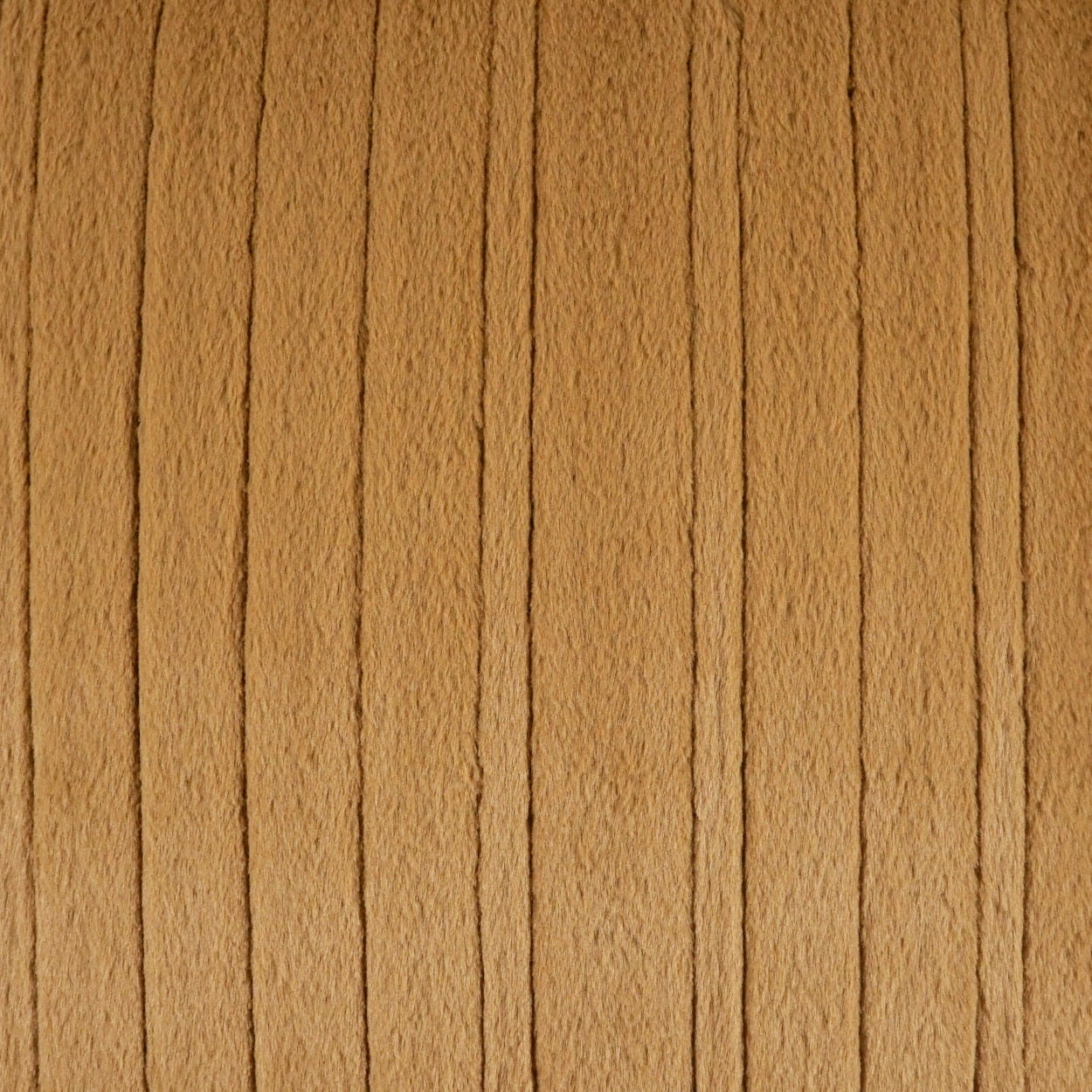 Tan corduroy fabric with evenly spaced vertical ridges; soft, warm camel color.