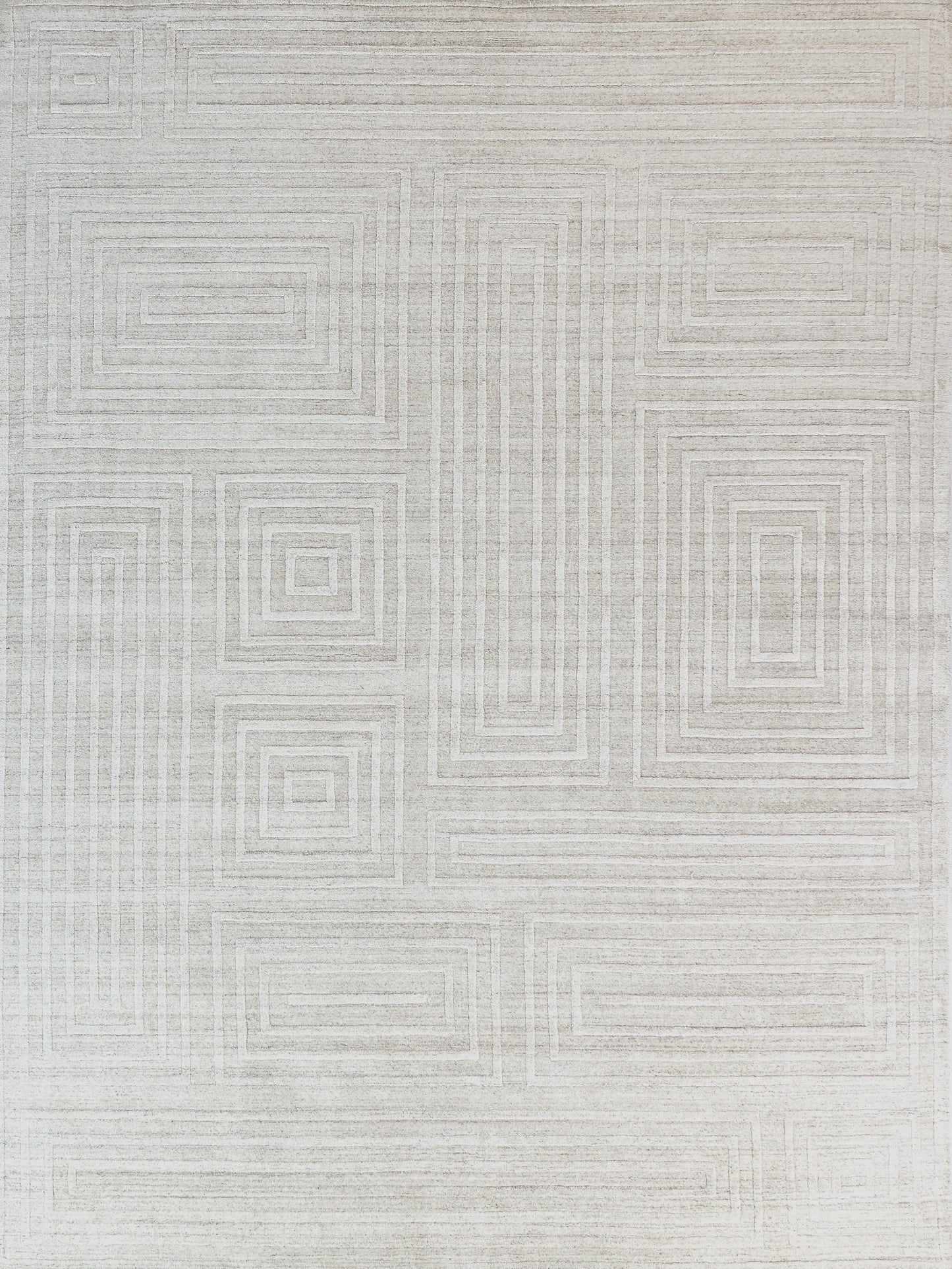 Light gray area rug featuring a subtle geometric pattern of interlocking squares and lines, soft texture for comfortable use.