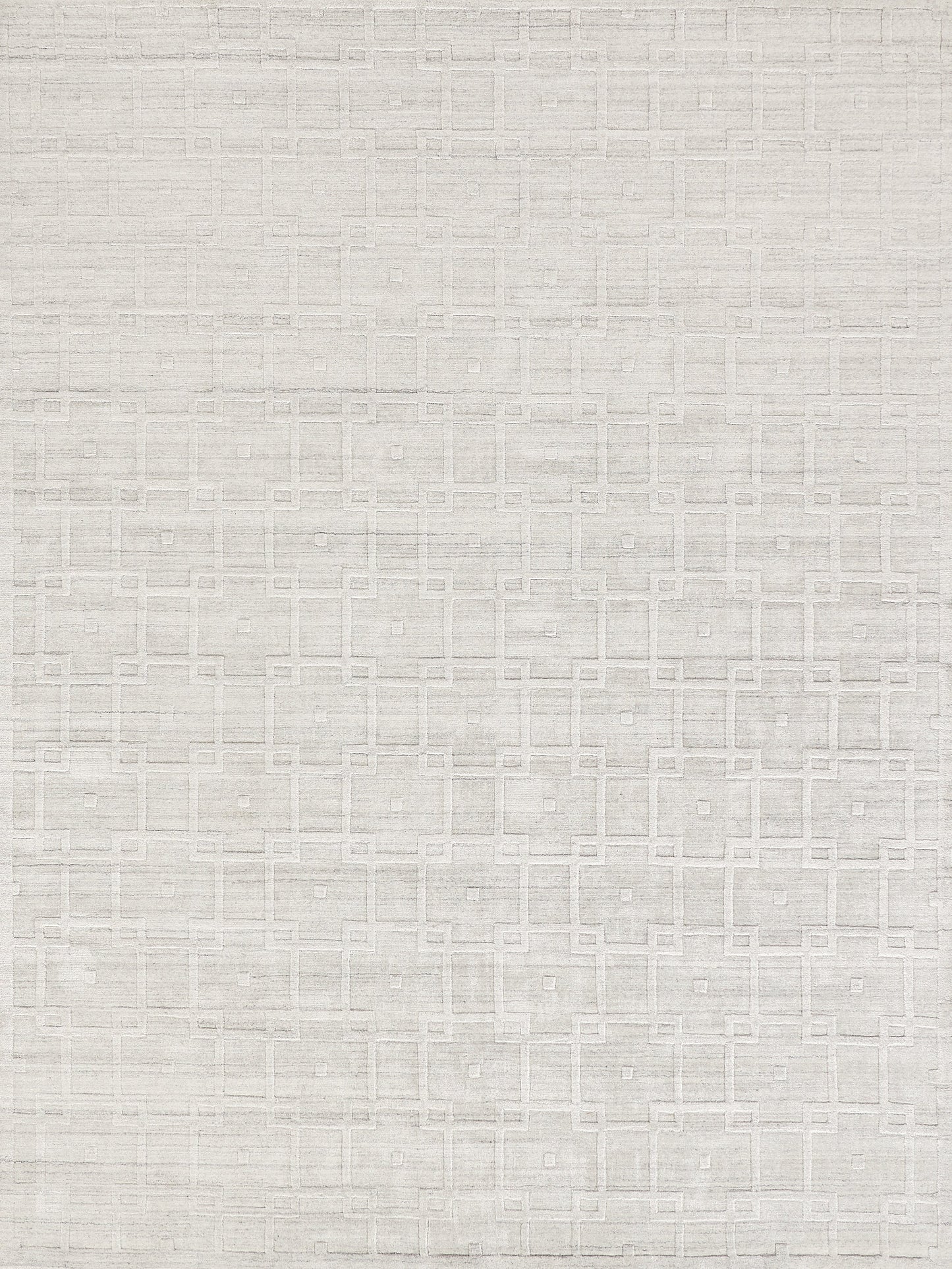 Textured light gray rug with a geometric pattern of squares and lines, offering a modern and elegant aesthetic.