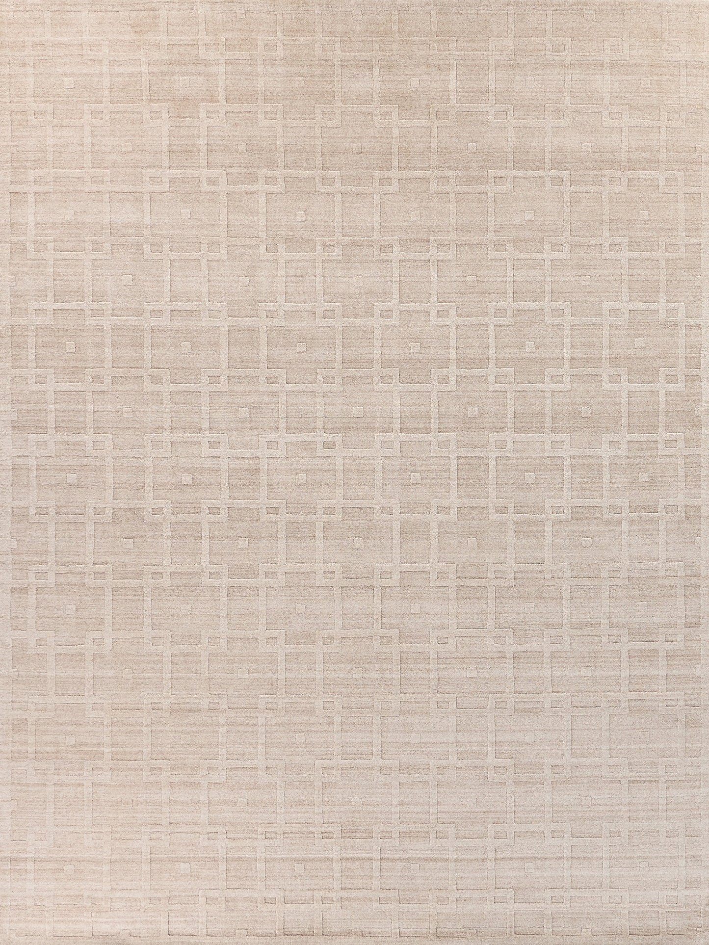 Light beige handloomed rug with a textured geometric pattern of squares and rectangles.