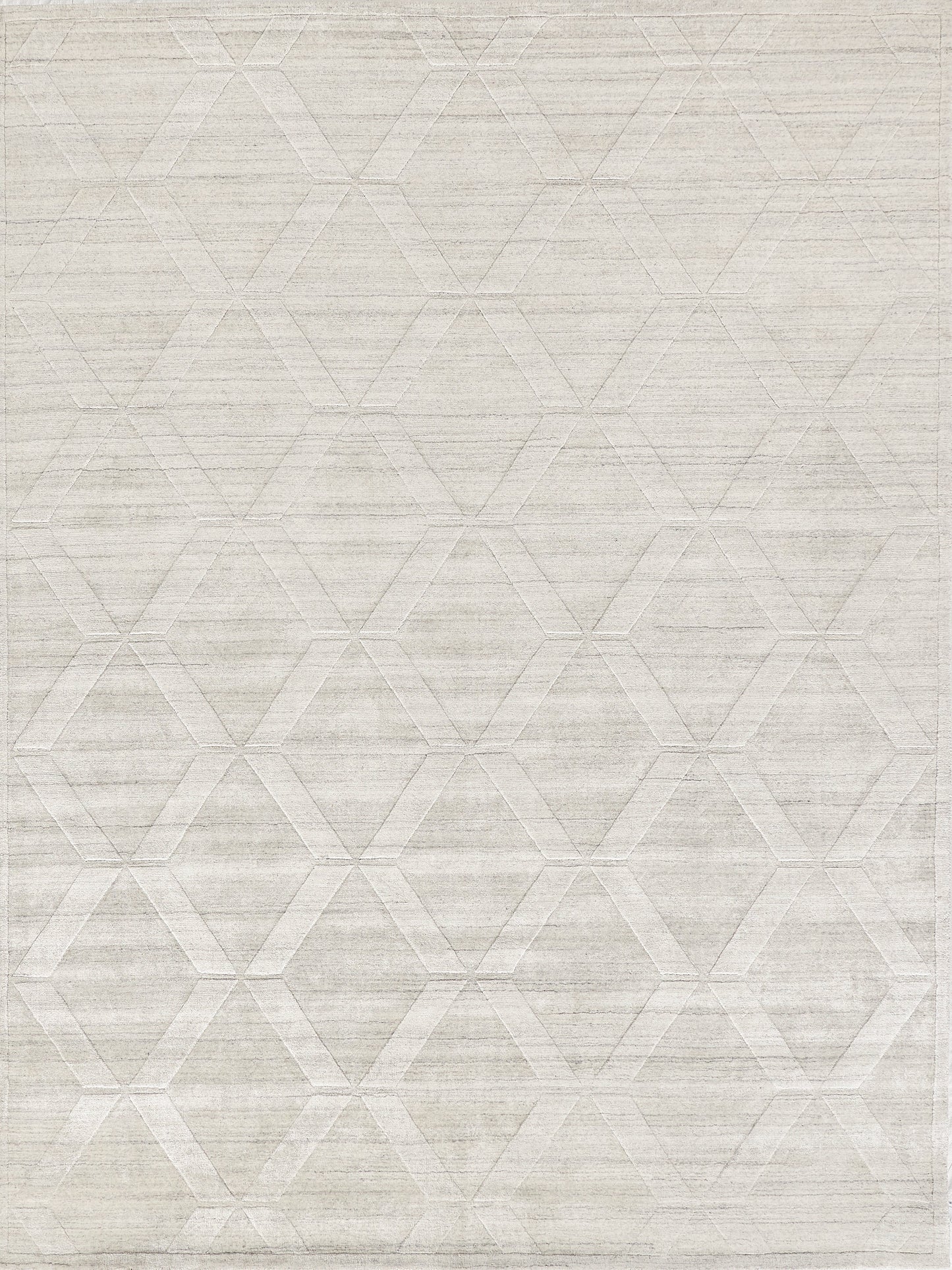 Light gray area rug featuring a geometric hexagon pattern with a subtle texture, ideal for modern interiors.