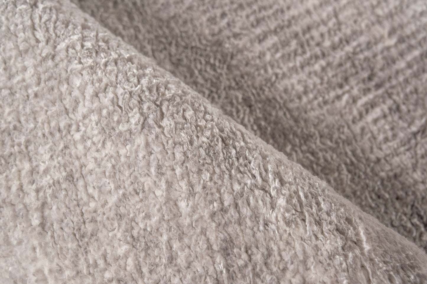 Beige plush rug close-up showing soft fluffy pile.