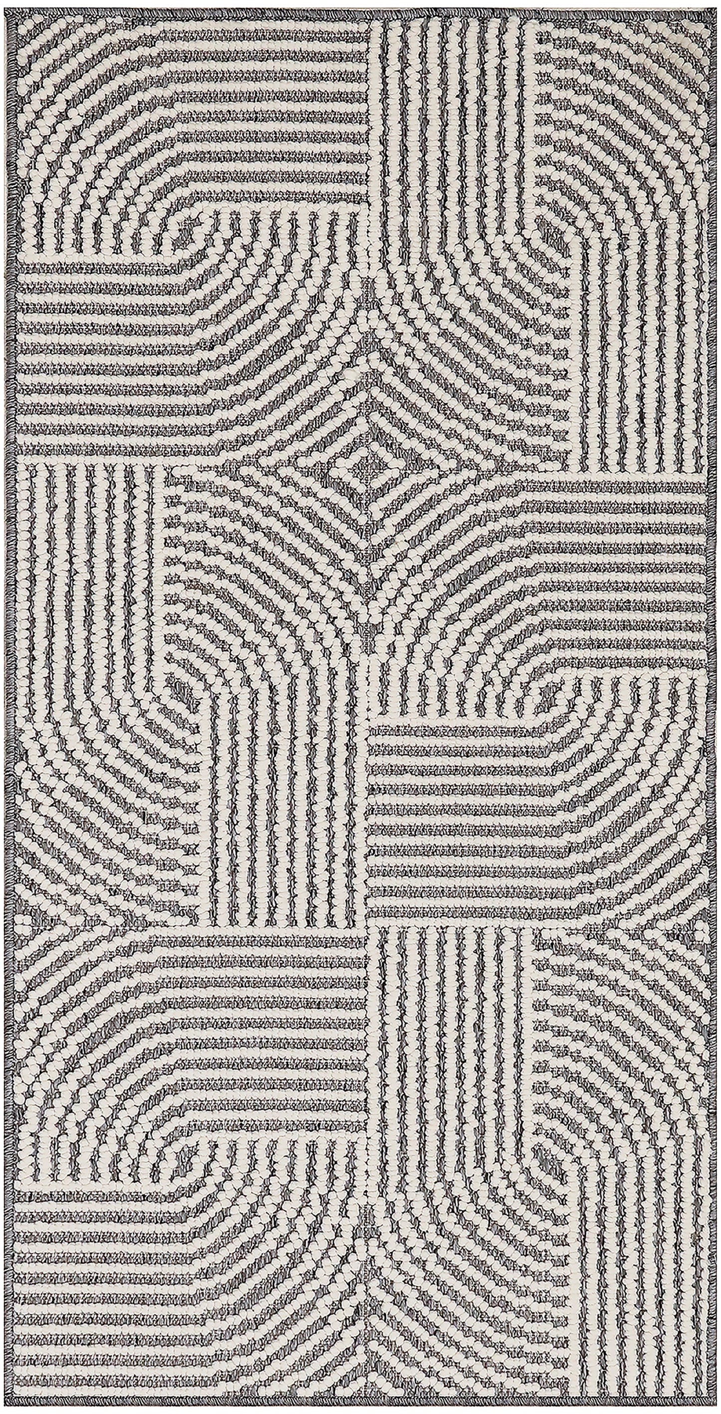 Cream and charcoal looped-pile rug with patchwork panels of striped, curved and grid-like patterns.