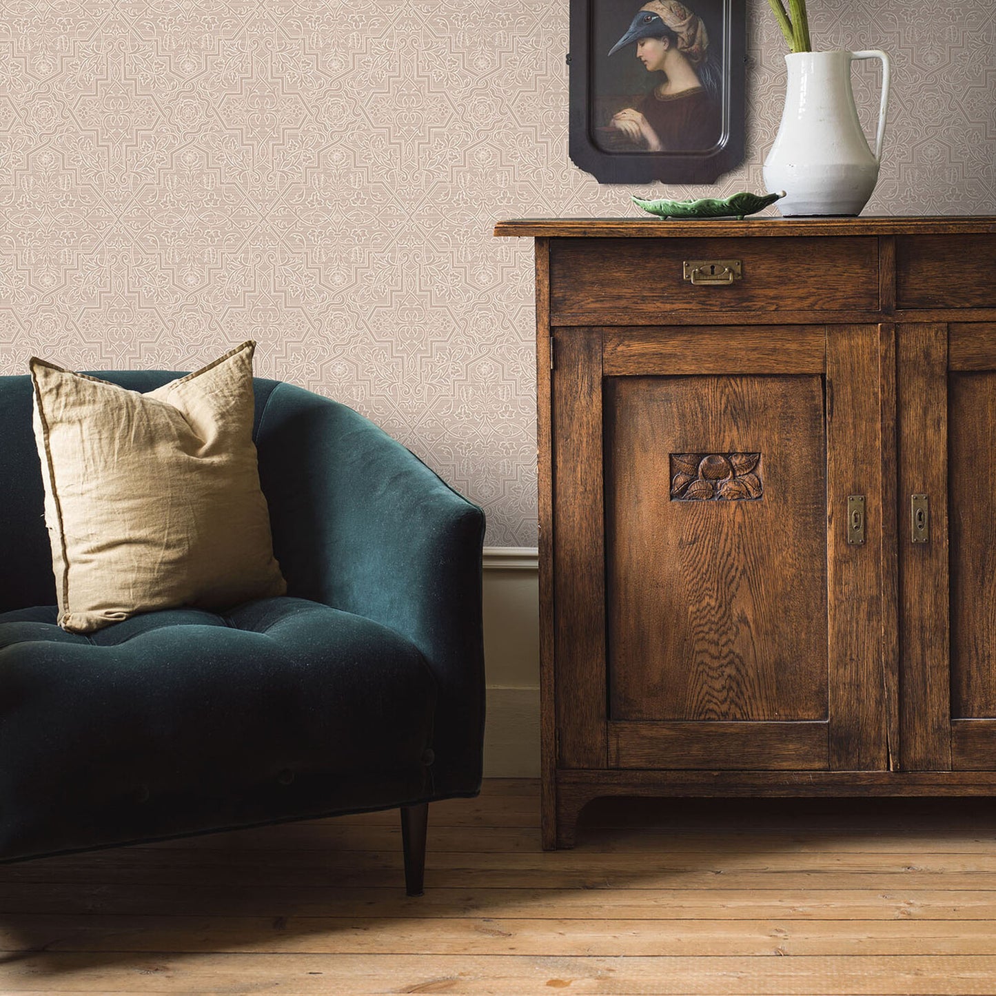 Patterned wallpaper in a natural tone visible in a living room scene with a carved wooden sideboard, pitcher, and framed art.