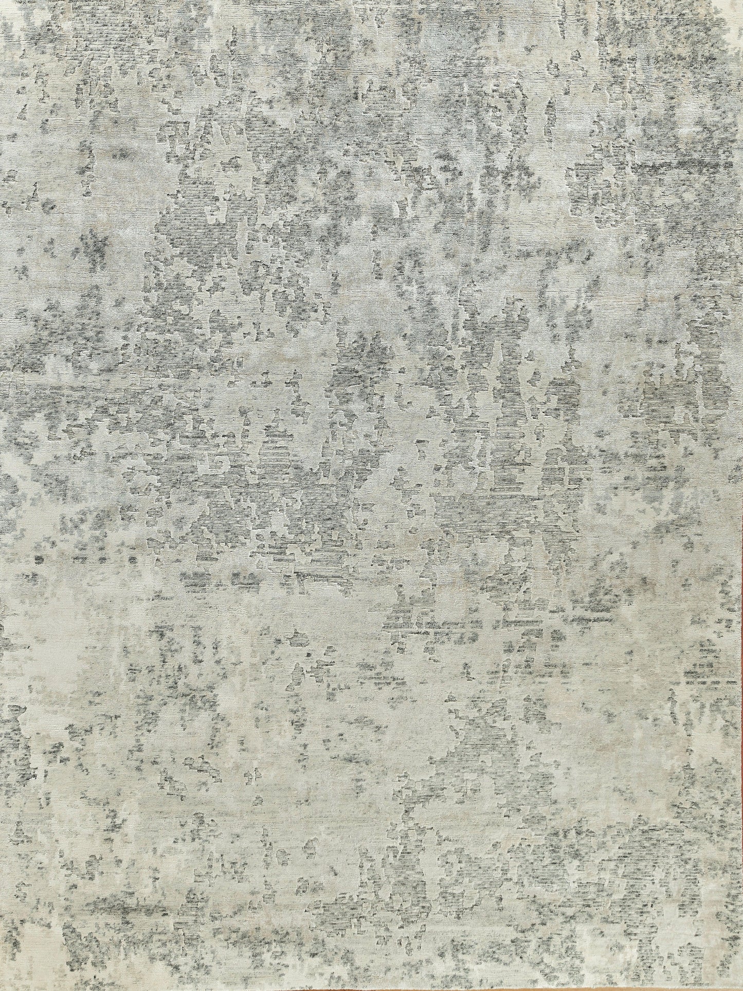 Distressed gray and ivory abstract area rug with a mottled pattern; neutral modern decor.