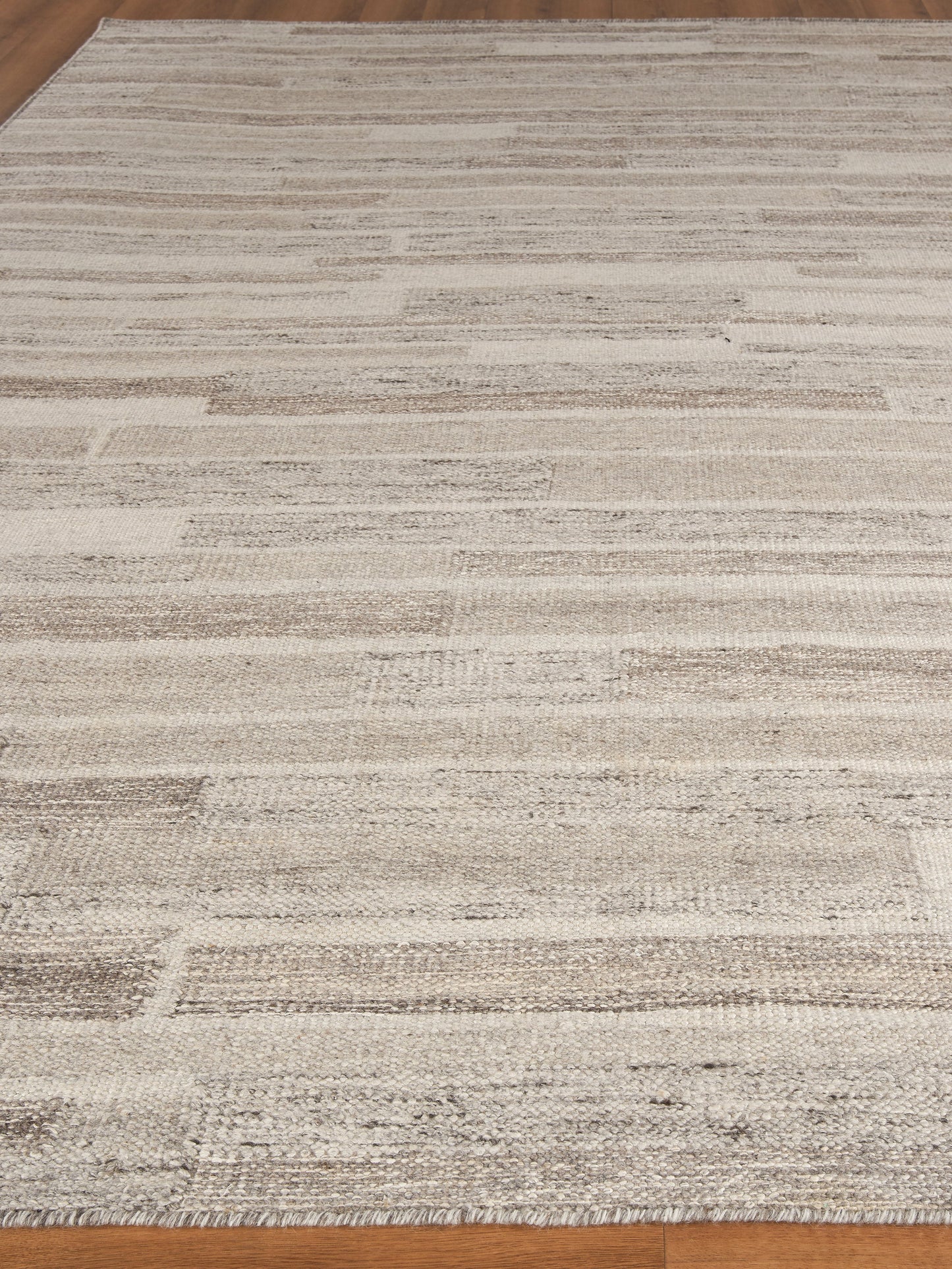 Beige cream striped hand loomed rug with subtle geometric blocks; modern neutral floor covering, 8' x 10'.