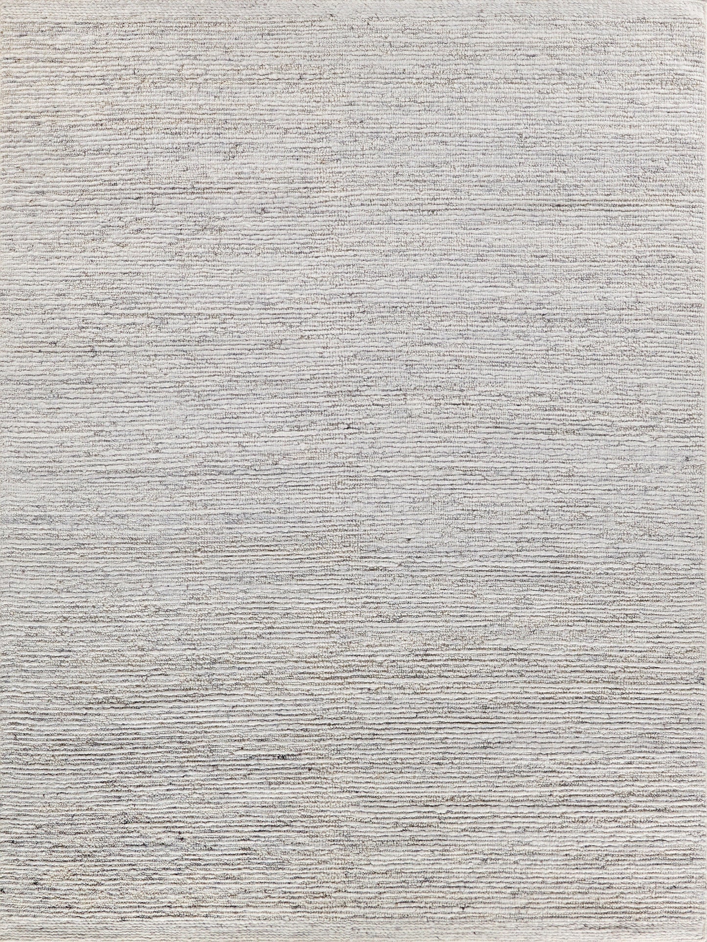 Light gray-beige flat-weave rug with subtle horizontal ridges; neutral, textured, modern decor.