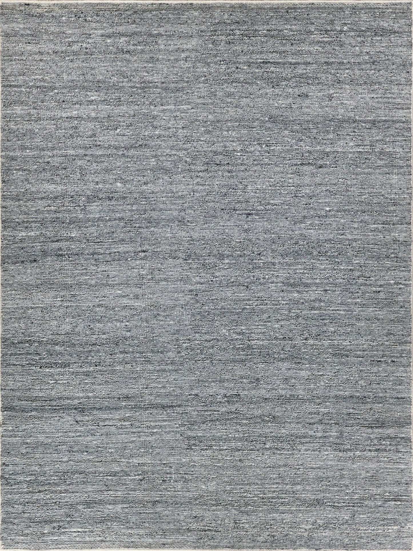Grey textured rug with subtle shading and variations; flat-weave, modern style for living room or bedroom.