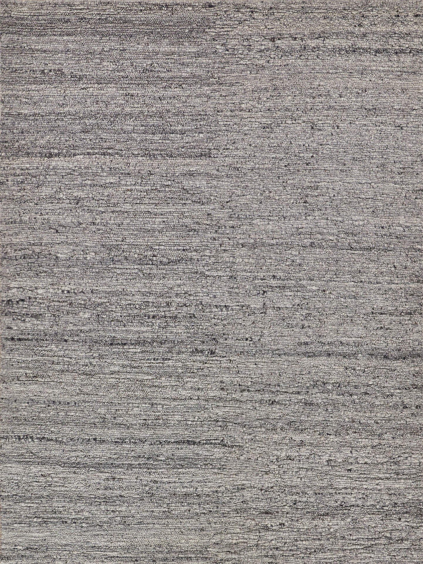 Gray textured woven rug with subtle horizontal striations; modern minimalist home decor.