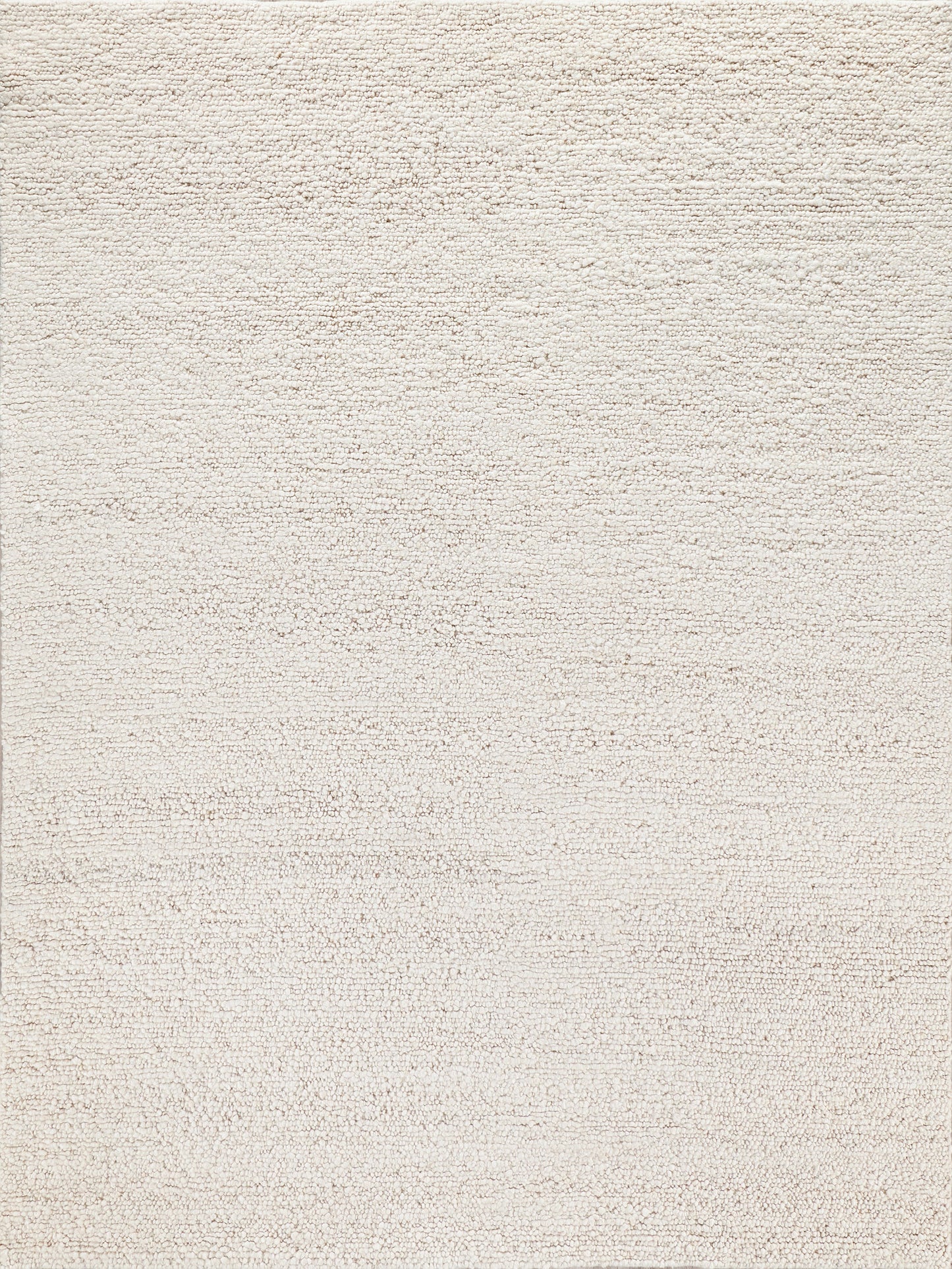 Light beige textured area rug with a soft, plush surface, ideal for adding warmth and comfort to any room.
