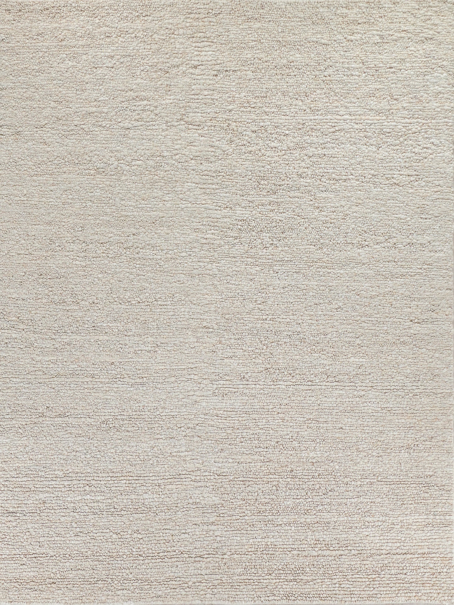 Neutral beige textured rug with a soft, plush surface, perfect for adding warmth to living spaces.