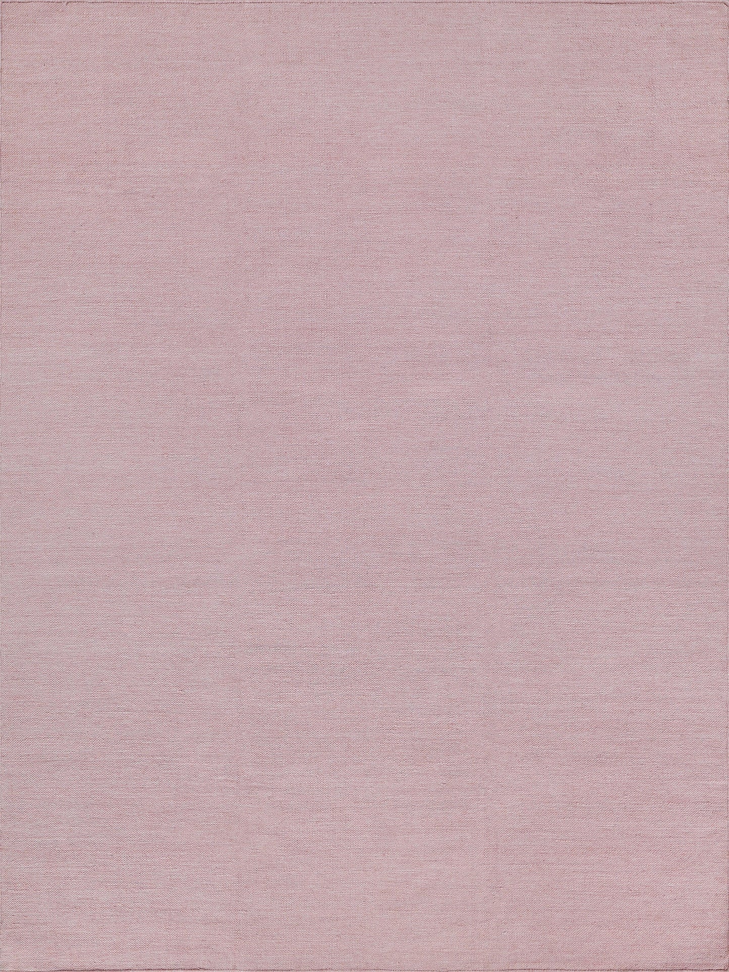 Soft pink rug with a subtle flat-weave texture.