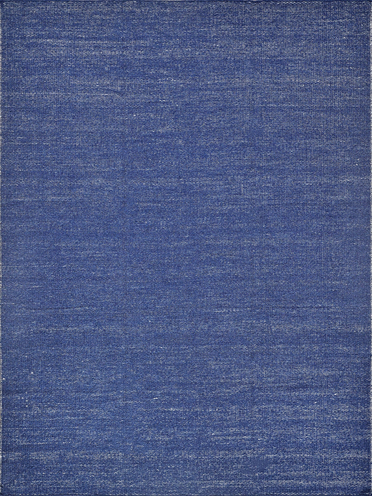 Indigo blue rug with brushed, textured surface and subtle light edges.