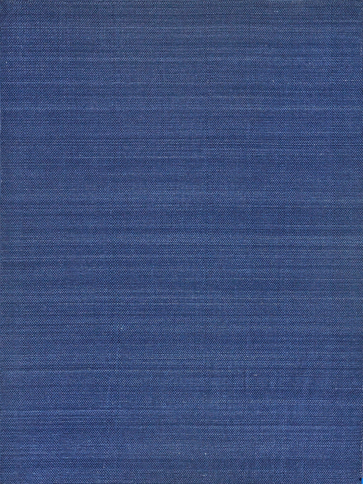 Blue flatweave rug with a subtle textured weave.