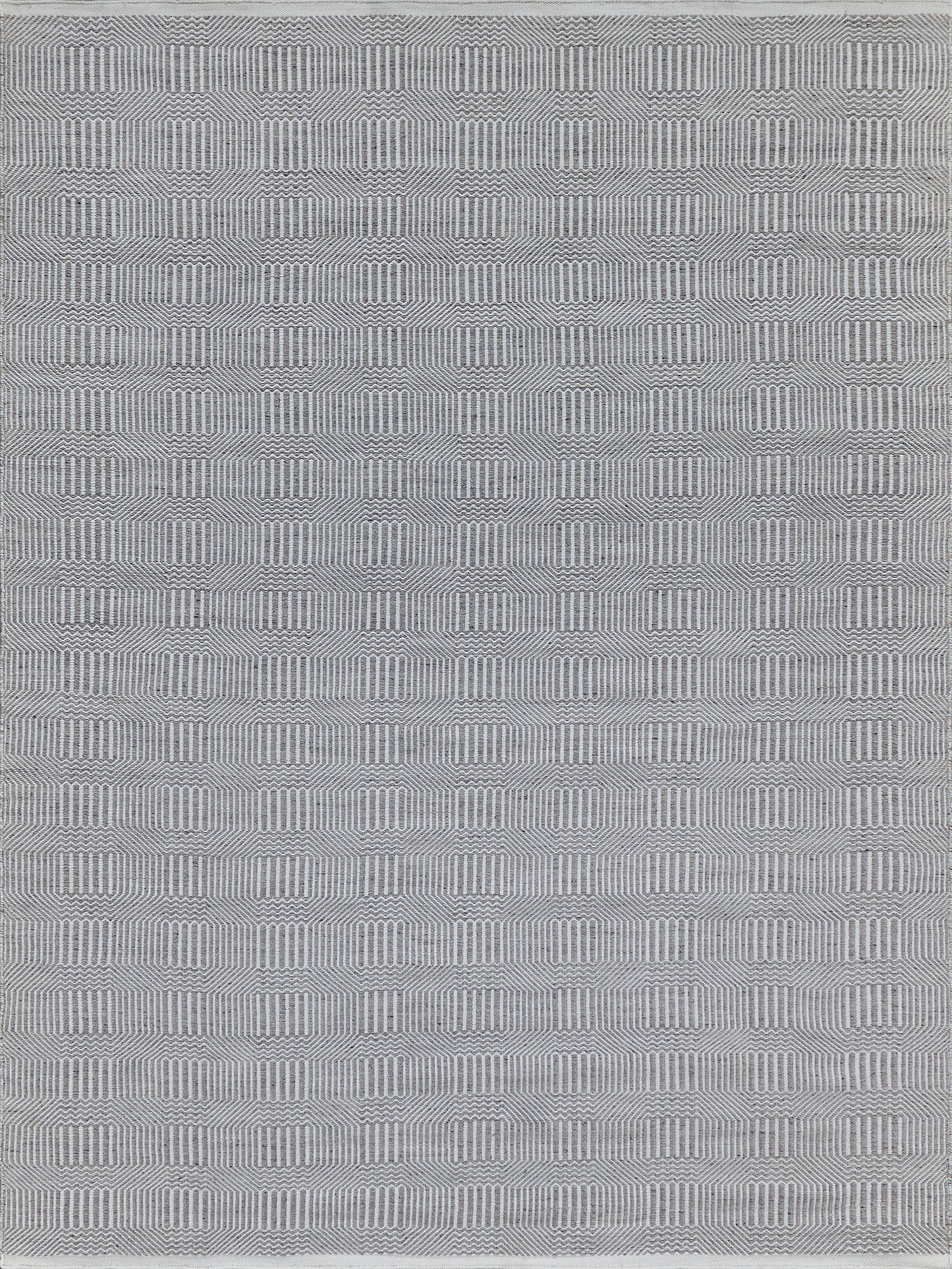 Gray flat-weave rug with a white geometric pattern of stacked rounded rectangles; modern, versatile indoor/outdoor decor.