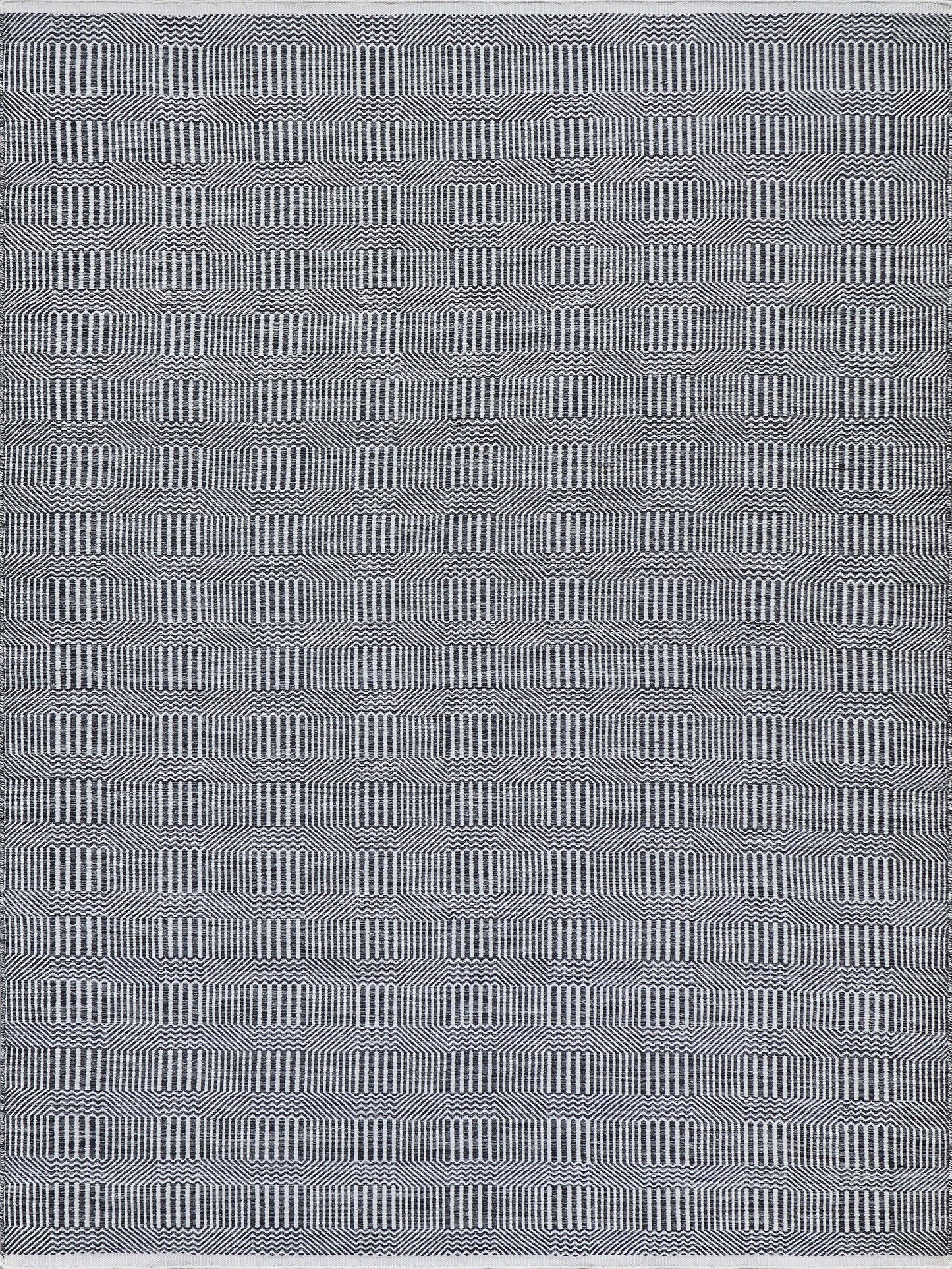 Navy blue and white geometric rug with repeating rounded-square motifs and vertical line patterns.