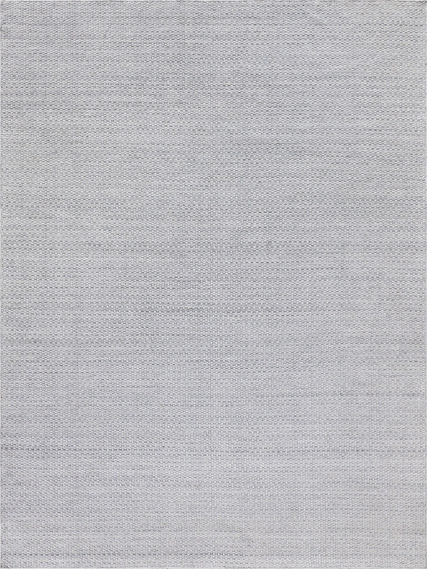 Rectangular flatweave rug in light gray with a textured surface.