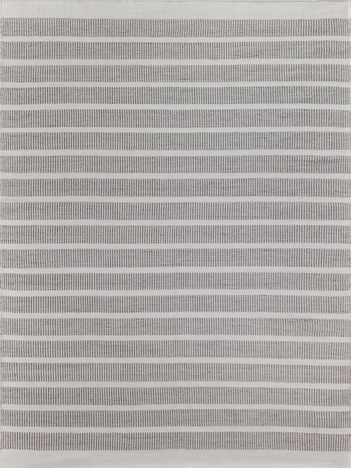 Grey striped flat weave rug with thin horizontal bands; indoor/outdoor use, 2' x 3'.