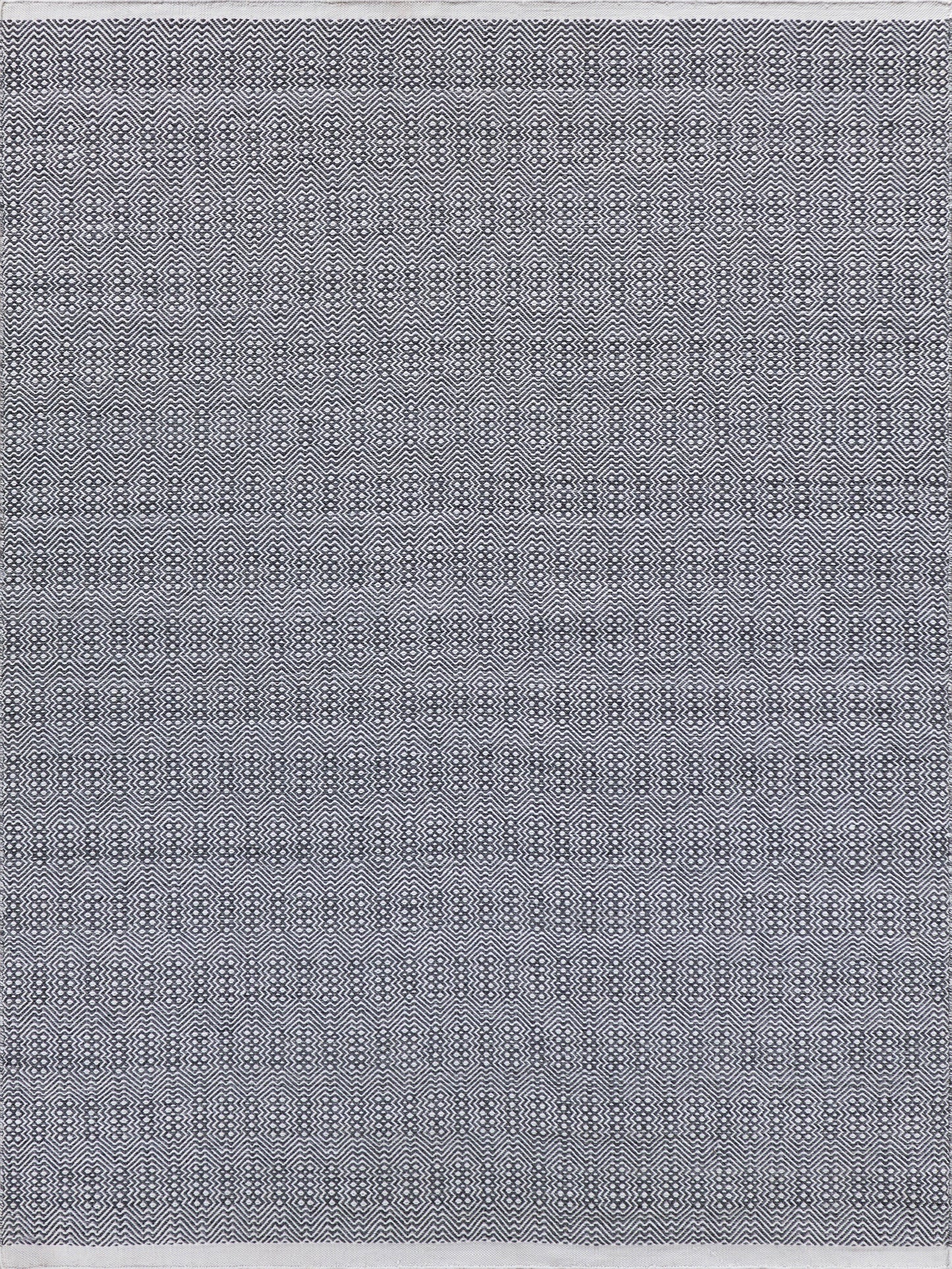 Navy blue and white flatweave rug with a geometric zigzag and oval pattern, rectangular.