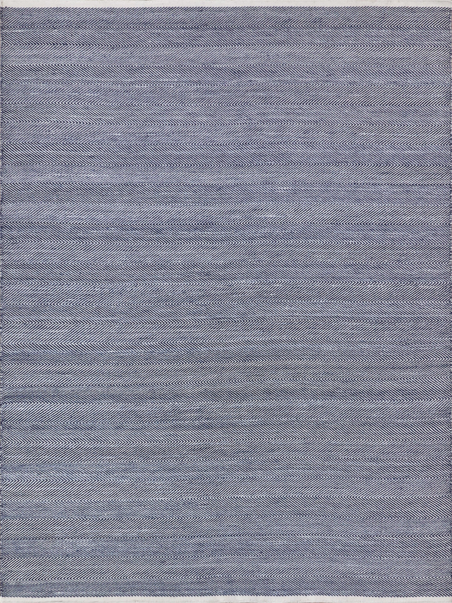 Navy & white herringbone flatweave rug in a rectangle shape, with a soft woven texture, suitable for home decor.