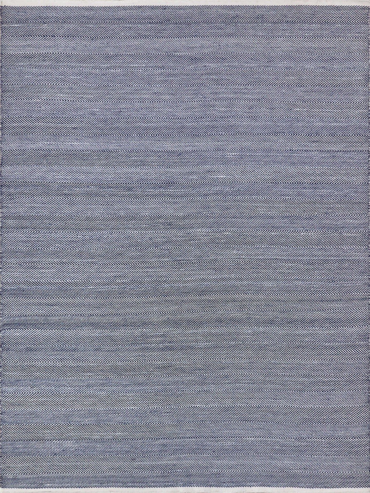 Navy and white herringbone-patterned flatweave rug, rectangular shape with a soft woven texture.