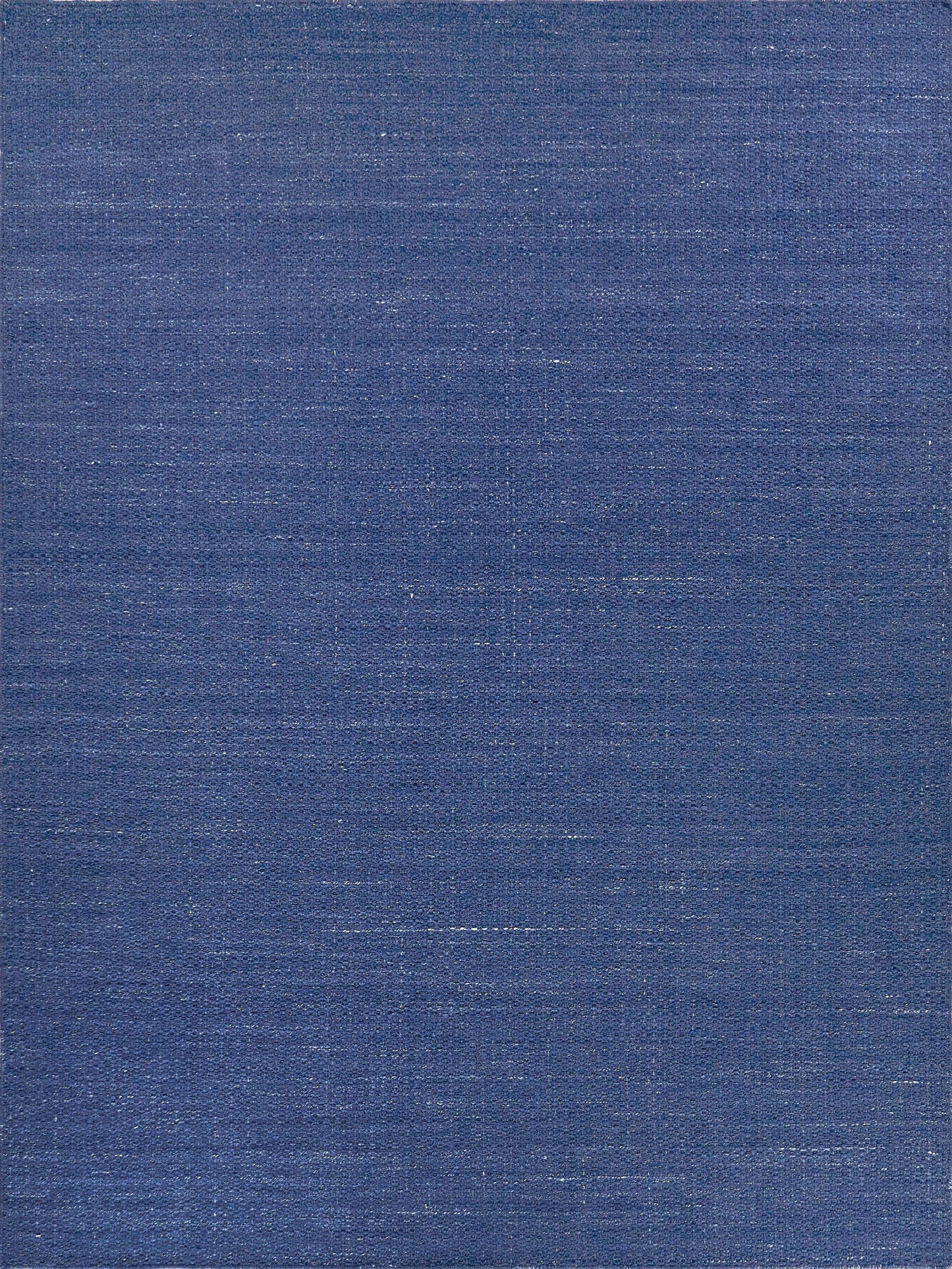 Deep blue flatweave rug with a subtle sheen, rectangular 9' x 12'.