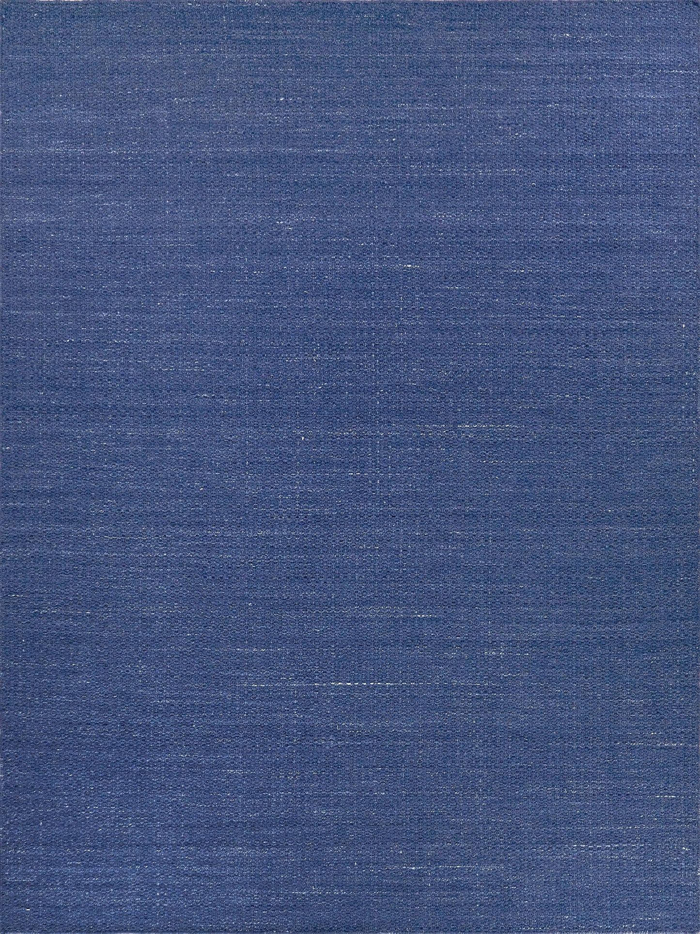 Dark blue flatweave rug with a textured weave, ideal for flooring in living spaces.