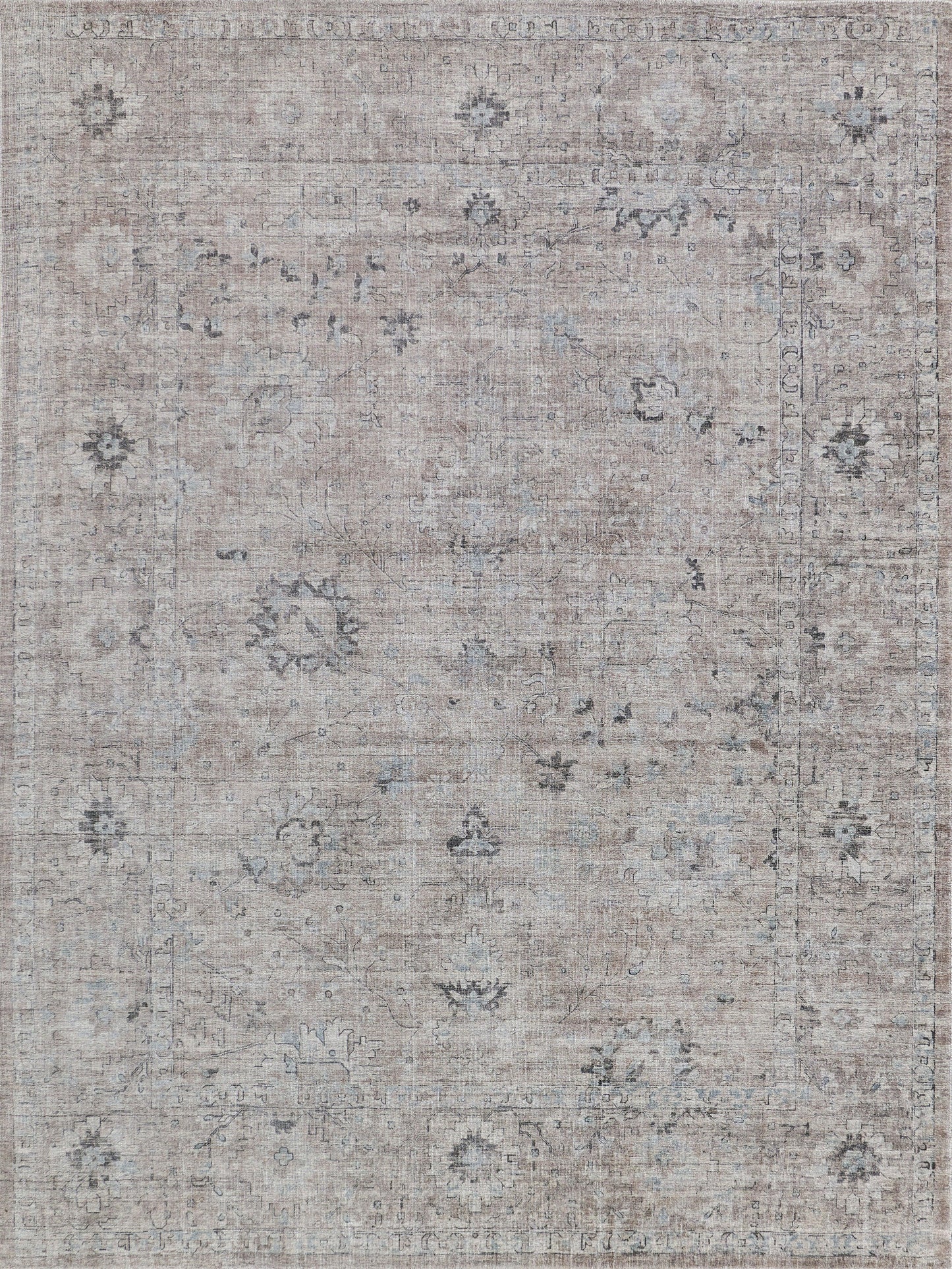 Muted beige area rug with floral patterns in gray and light blue tones, featuring an antique distressed finish.