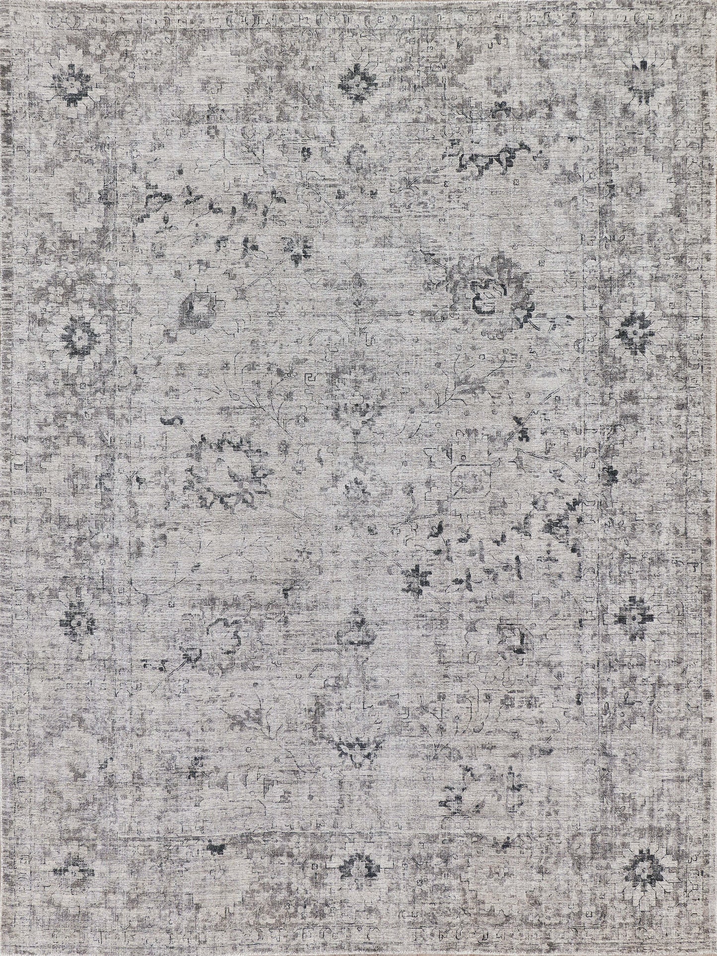 Vintage-style area rug with intricate gray floral patterns on a light beige background, adding elegance to any space.