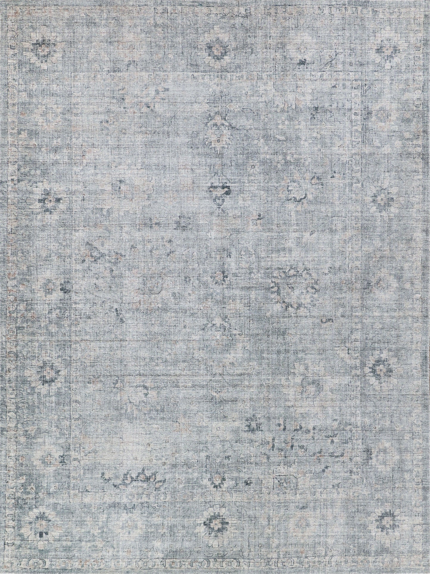 Light blue vintage-style area rug with subtle floral medallions and distressed borders, soft-pile, decorative accent rug.