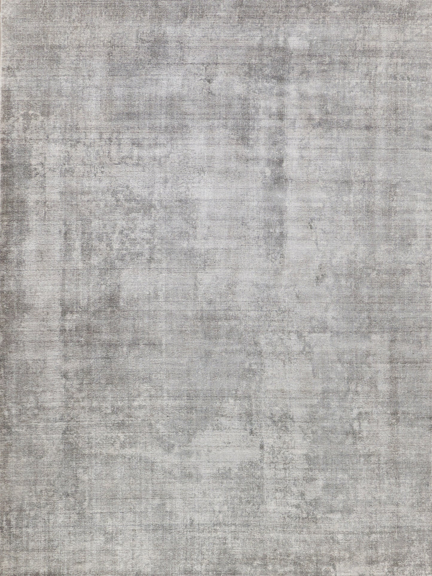 Gray distressed rug with a washed, mottled texture; indoor hand-loomed, stone-washed.