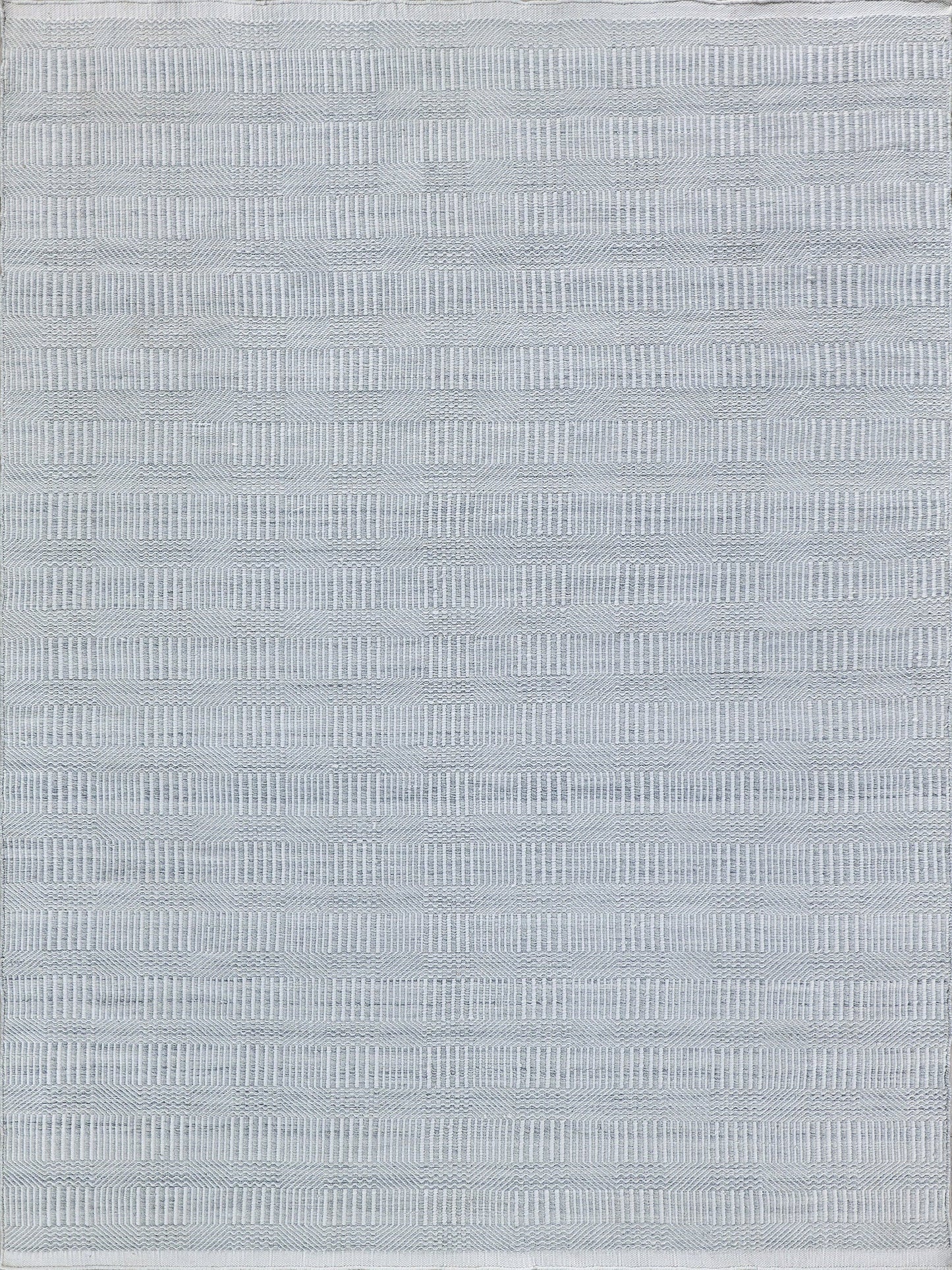 Light gray rug with flat-weave indoor/outdoor design; fine horizontal ribbing and subtle striped texture; soft, versatile.
