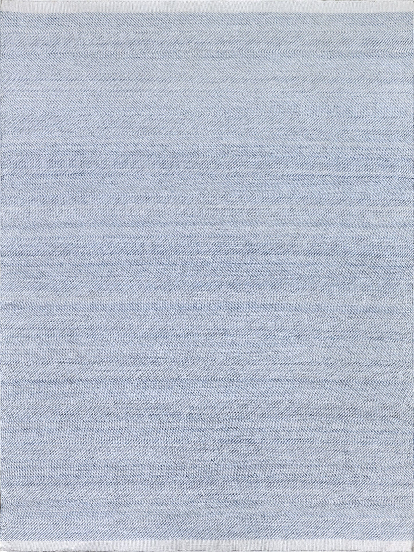 Light blue flatweave rectangle rug with a subtle herringbone pattern and thin stripes.