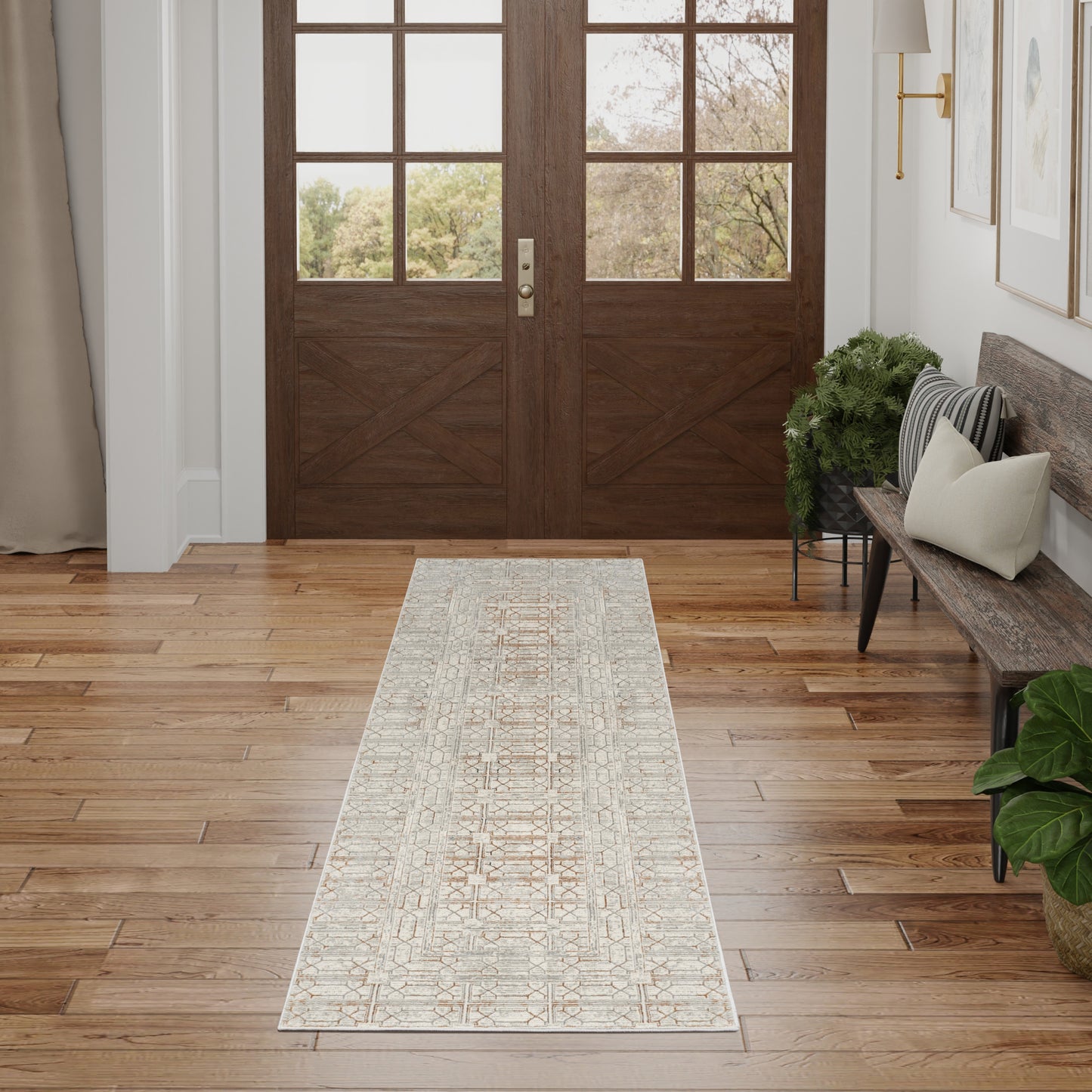 Long beige and ivory woven runner rug with geometric pattern in a foyer on wood floors.