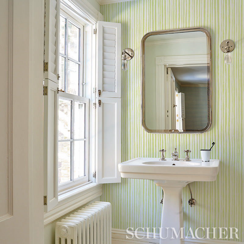 White wall covered with lime-green striped wallpaper; sketch-style stripe pattern.