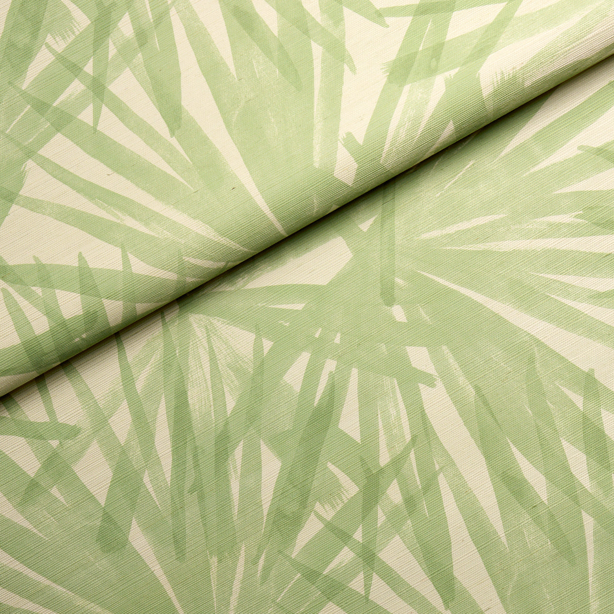 Light green fabric with abstract palm leaf print, rolled at the top.