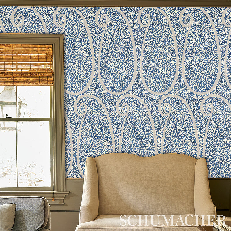 Blue and white paisley wallpaper with a grasscloth texture, shown with a bamboo window shade.