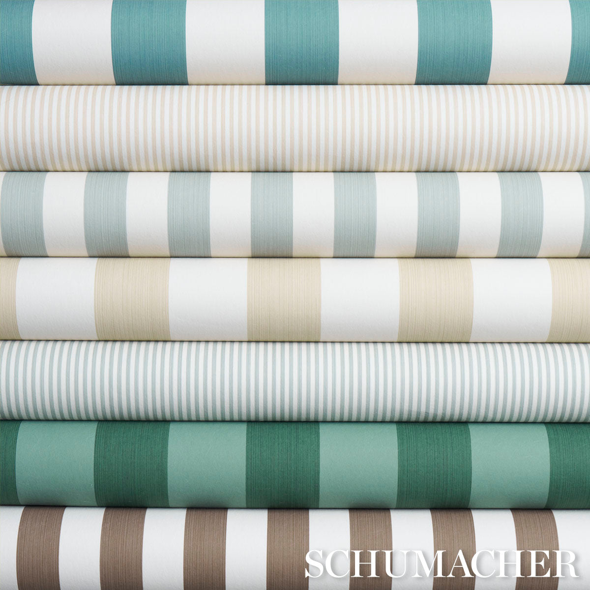 Stack of rolled striped fabrics in teal, mint, beige & white; classic upholstery & drapery textiles.