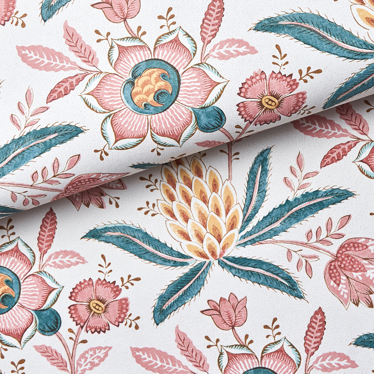 Floral fabric in pink, teal, and yellow with leaves on white; botanical pattern, cotton-like material.