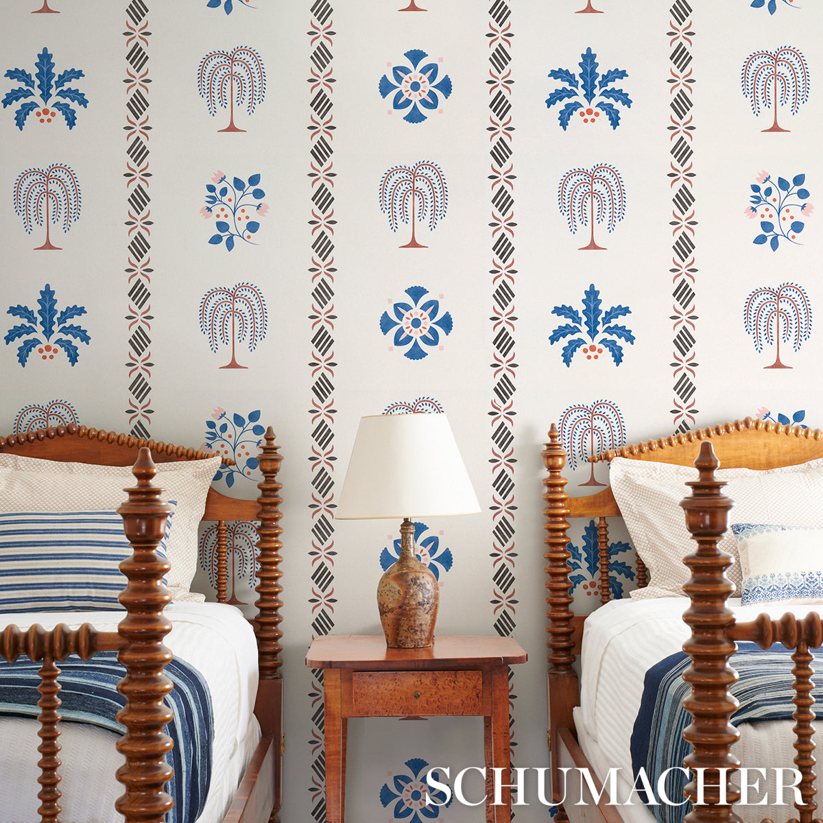 Blue stencil wallpaper in a vintage bedroom setting.