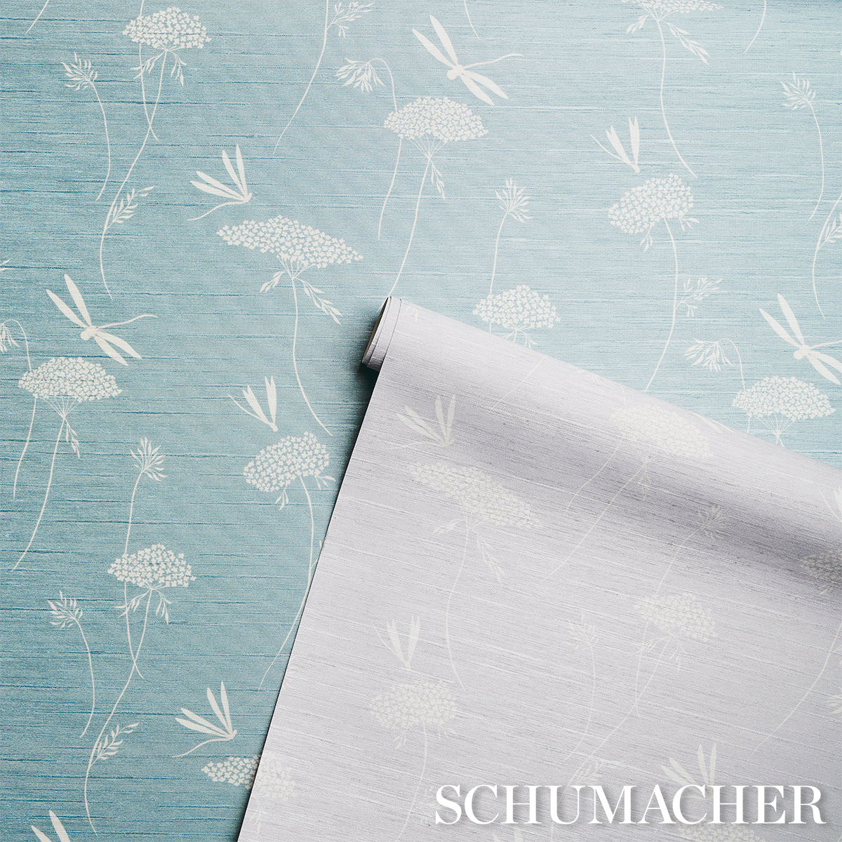 Light blue grasscloth wallpaper with a silk texture; rolled sheet partially unrolled.