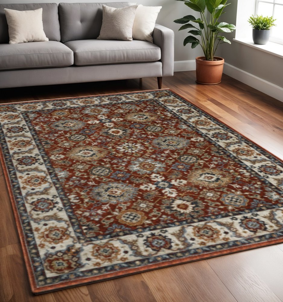 5' X 8' Red Blue Ivory Gold And Navy Oriental Power Loom Stain Resistant Area Rug With Fringe