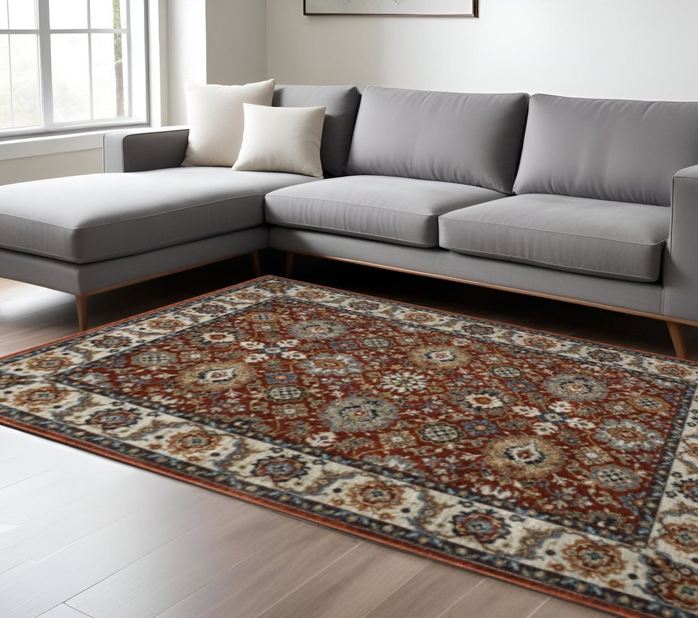 10' X 13' Red Blue Ivory Gold And Navy Oriental Power Loom Stain Resistant Area Rug With Fringe