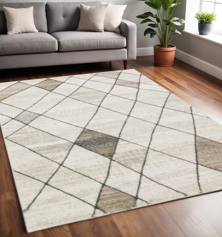 5' X 8' Beige Grey Tan And Brown Geometric Power Loom Stain Resistant Area Rug