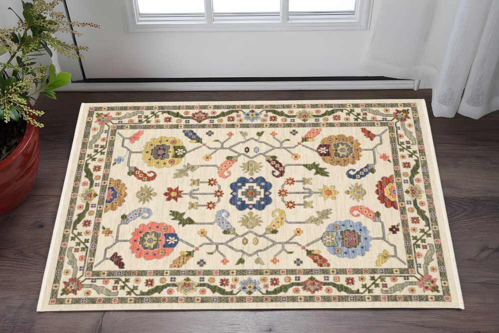 3' X 5' Ivory Green Blues Pink Yellow Rust Brown Tan And Grey Oriental Power Loom Stain Resistant Area Rug With Fringe