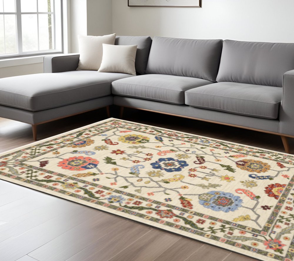 6' X 9' Ivory Green Blues Pink Yellow Rust Brown Tan And Grey Oriental Power Loom Stain Resistant Area Rug With Fringe