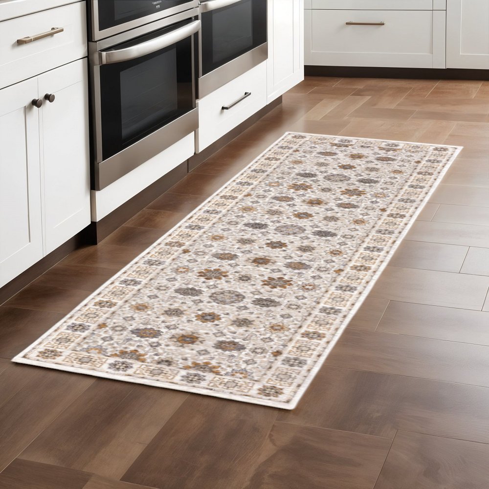 2' X 8' Ivory And Gold Oriental Power Loom Stain Resistant Runner Rug With Fringe