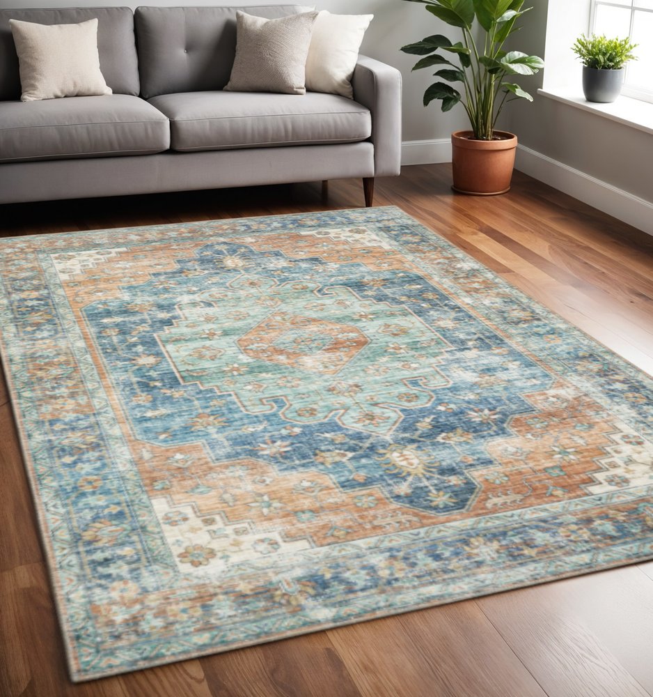 5' X 7' Orange Blue Teal Green And Beige Oriental Power Loom Stain Resistant Area Rug