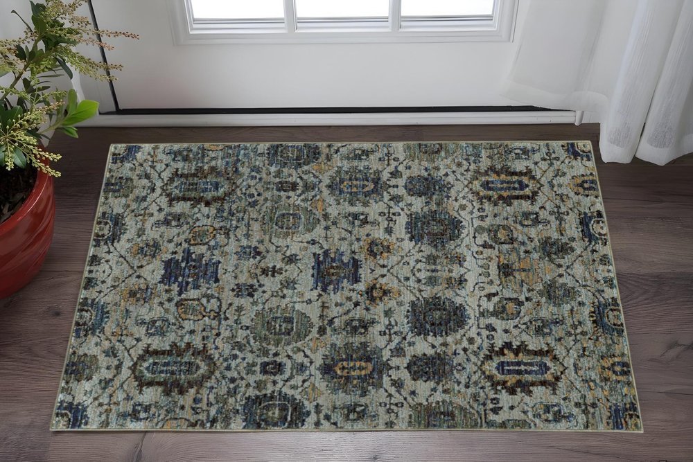 Rectangular distressed oriental area rug in blue, beige and teal with floral medallion pattern; ideal for living rooms.